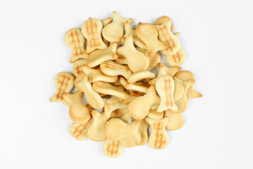 Pile of salty crackers isolated on white background. Fish shaped snack