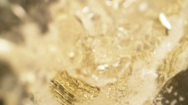 Super slow motion of pouring champagne into glass with camera motion. Filmed on high speed cinema camera, 1000 fps.