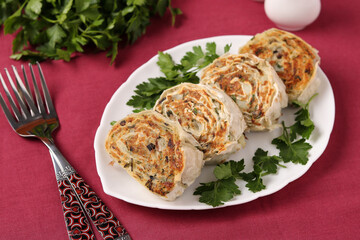 Fried lavash rolls with potatoes and mushrooms are located on white plate. Closeup. Horizontal format