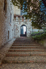 The stone stairs in the old castle in Brescia. Castle of Brescia, Via del Castello, the ancient part of Brescia. Called the Falcon of Italy, one of the largest fortified complexes in Italy.