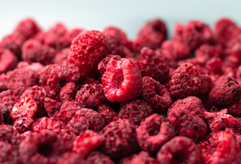 Heap of freeze dried raspberries close-up. Dehydrated food background