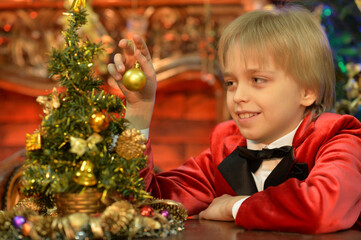 cute boy decorating Christmas tree