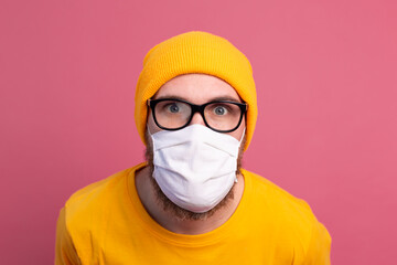 Caucasian young man in glasses with single use medical mask to prevent infection, respiratory disease such as flu