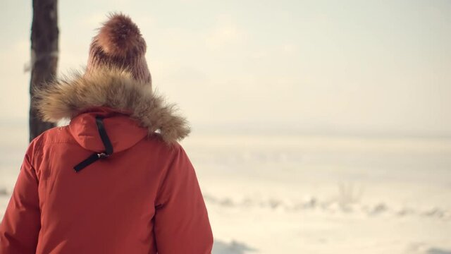 Holiday Vacation Tourist Journey Trip In Cold Day.Walking In Winter Greenwood With Snow.Snowy Trees.Carefree Girl Exploring Wood Forest In Winter Snowy Sunny Time.Woman In Parka Walking In Pine Forest