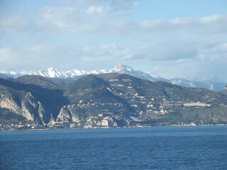 view towards the cote d’azur with the snow capped mediterranean alps in the background, france