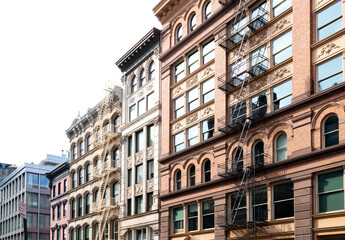 Block of old historic buildings with windows and fire escapes in the SoHo neighborhood  of Manhattan New York City