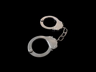 Iron handcuffs on black background
