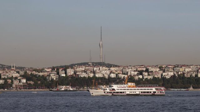 Local ships and ferries passing through the bosporus in the background Camlica TV tower and Istanbul's Asian side neighborhood names Salacak Harem Uskudar
