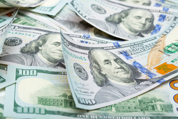 One hundred dollar bills are creatively laid out. Beautiful original cash flow. One hundred bucks as a background on a long banner in high resolution.