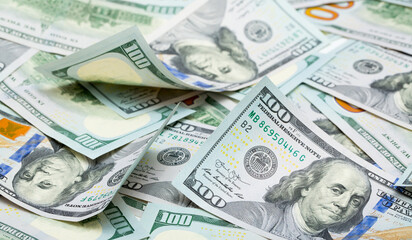 One hundred dollar bills are creatively laid out. Beautiful original cash flow. One hundred bucks as a background on a long banner in high resolution.