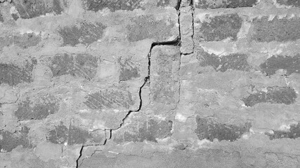 A large crack in the stone wall from the impact of the earthquak