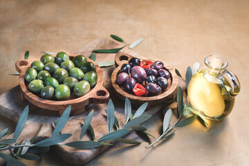  Still life of Mediterranean pickled olives for the for tapas or antipasti in olive wooden bowls