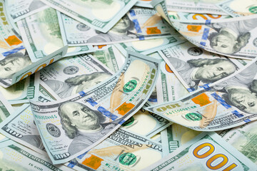 One hundred dollar bills are creatively laid out. Beautiful original cash flow. One hundred bucks as a background on a long banner in high resolution.