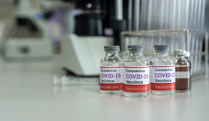 Concept of the coronavirus vaccine covid-19, in vitro. And a bottle of the vaccine against COVID-19 In medical science laboratories