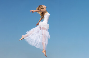 Angel fairy flying ease girl in white dress in sky background. Happy wedding concept.
