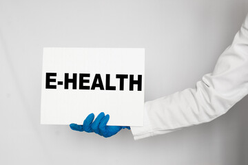 The doctor's blue - gloved hands show the word E-HEALTH - . a gloved hand on a white background. Medical concept. the medicine