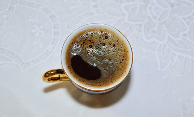 close-up - there is a cup of hot natural coffee on the table