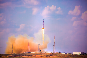 A real Soyuz in flight, a launch vehicle from the Baikonur Cosmodrome. Rocket take off in the sky against the background of clouds. Startup concept, power of science and technology.