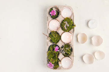 diy for Easter holiday. Egg shell in the form of a candlestick on a white background. copy space