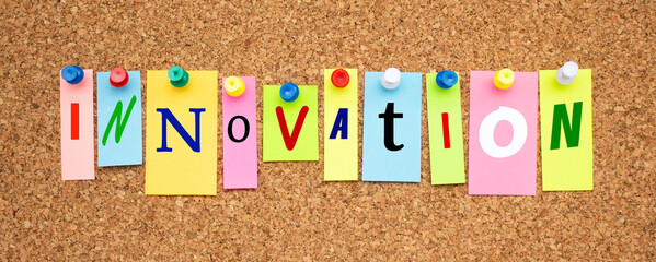 Color notes with letters pinned on a board. Word INNOVATION.