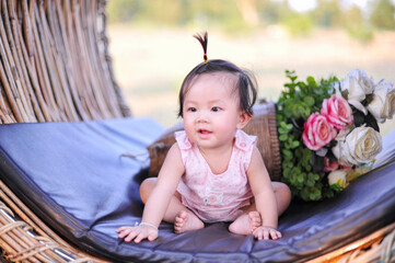 Portrait asia baby girl of 8 months old enjoying, Cute infant child toddler sitting in pink dress