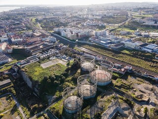 Obraz premium Aerial view of an abandoned oil plant and refinery in Lisbon countryside at sunset, Portugal.