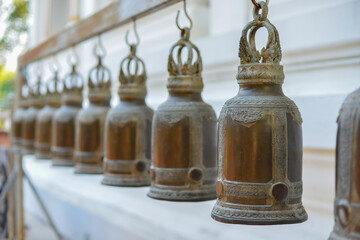 Many bells hung on the rail. - Powered by Adobe