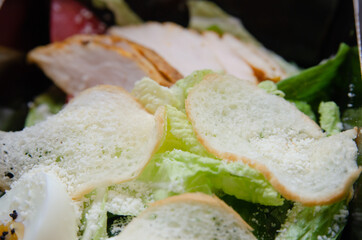 Salad with meat, vegetables and herbs. Pieces of meat. Close-up