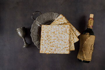 Jewish Passover attributes in composition a cup full of wine and passover matzah