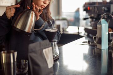 Happy smiling professional barista in cafe