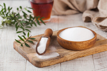 Natural sweetener in a wooden spoon. Sugar substitute. Erythritol - obrazy, fototapety, plakaty