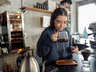 Happy smiling professional barista in cafe