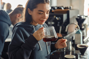 Happy smiling professional barista in cafe
