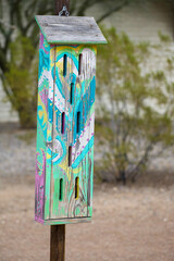 Colorful painted wood butterfly house in park