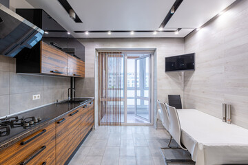 interior photo of a modern large kitchen in dark colors of wood