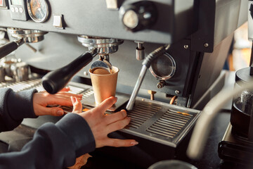 Happy smiling professional barista in cafe
