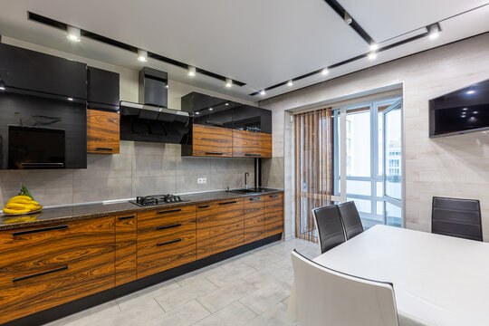 interior photo of a modern large kitchen in dark colors of wood