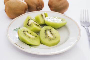 slices of kiwi in a plate on a white
