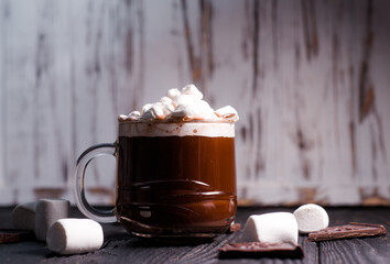 Delicious cocoa with marshmallows in a beautiful glass