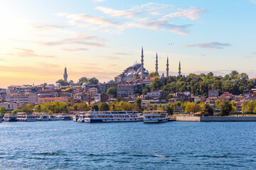 Eminonu Pier near the Suleymaniye Mosque in Istanbul, view from the Bosphorus at sunset