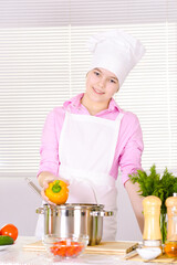 beautiful  girl wearing chef uniform cooking