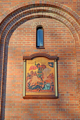Temple icon in an arched niche on the facade of the chapel of St. George the Victorious. Kaliningrad