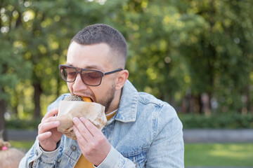 High calorie food. Cheat meal. Delicious burger concept. Enjoy taste of fresh burger. Hipster hungry man eat burger. Man with beard eating burger.