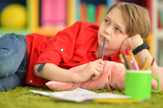 Portrait of cute little boy drawing