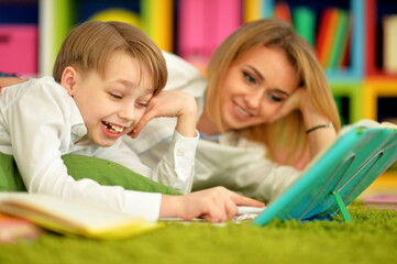 Obraz premium Mother with her son doing homework at home
