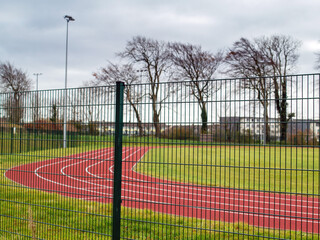 Brand new track for running. Red color, nobody. Outdoor activity and sport concept.