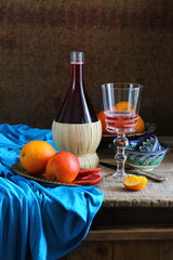 Still life with red wine and citrus