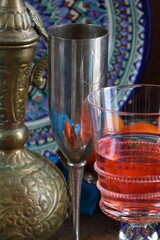 Oriental still life with red wine and oranges on wooden background