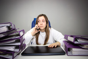 Busy businesswoman under stress due to excessive work talk on phone.