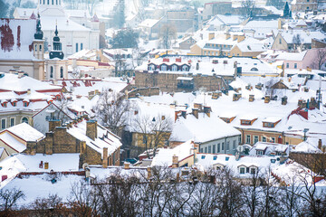 Fototapeta na wymiar Aerial view of Vilnius old town, capital of Lithuania in winter day with roof covered by the snow